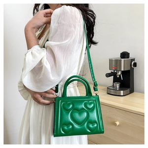 Sac bandoulière vert en similicuir avec motif cœur gaufré et bandoulière ajustable