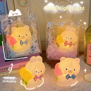 Detail of cute bear and rabbit tulip night lights in transparent gift packaging with handles