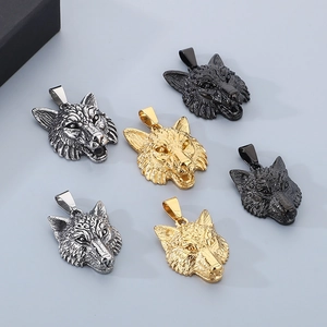 Detailed view of Viking wolf head pendants in gold, silver, and black finishes