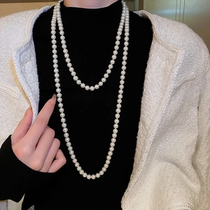 Close-up of elegant double-layered white pearl long necklace with soft lustrous finish