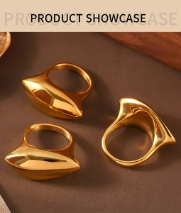 Three gold geometric rings with 3D pointed design showcased on a warm brown background