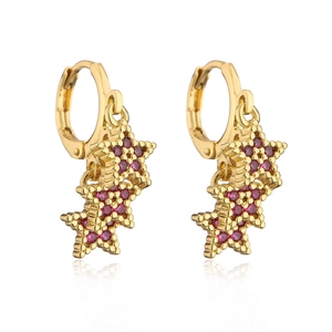 Detail of 18K gold plated copper earrings with red zircon-studded triple star pendants