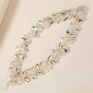 Detail of handcrafted bridal headband with crystal rhinestones and silver leaves decoration