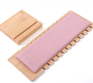 Detail view of pink velvet necklace display stand with 12 side notches and bamboo frame