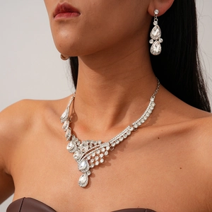 Luxurious silver waterdrop crystal necklace and earring set worn by model for weddings