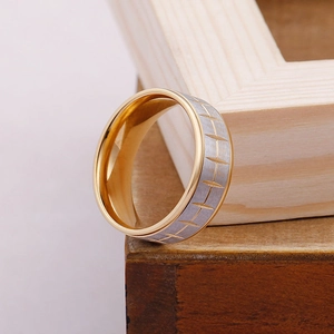 Detail shot of a two-tone titanium steel ring with distinctive tire tread patterns