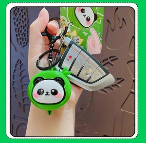 Close-up of cute green panda keychain with retractable cord and acrylic PANDA tag