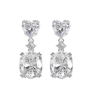 Detail of luxury heart and cushion cut zircon earrings in silver finish showing sparkle