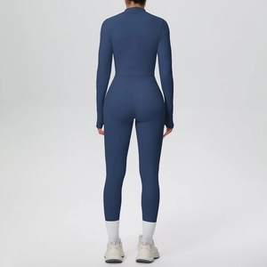 Detail of slim-fit navy blue sports jacket and high-waisted yoga pants from a back view