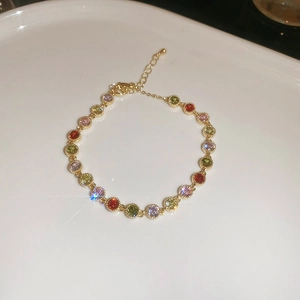 Detail of multi-colored round zircon bracelet with gold plating and lobster clasp