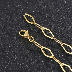 Detailed shot of golden hollow rhombus link bracelet with a secure lobster clasp closure