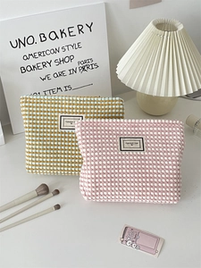 Detail of checkered knit cosmetic bags showing woven texture and pleasant time label