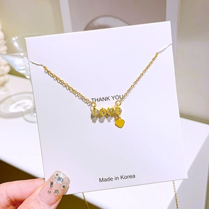 Golden titanium steel necklace with sparkling LOVE pendant and yellow heart charm