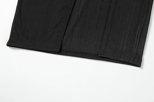 Detailed macro view of the knitted ribbed fabric texture and fine stitching on a black dress