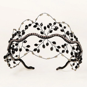 Detail of handcrafted black beaded tiara with silver rhinestones and leaf pattern