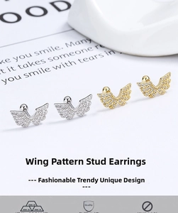 Detail view of silver and gold wing screw-back stud earrings with pavé cubic zirconia stones