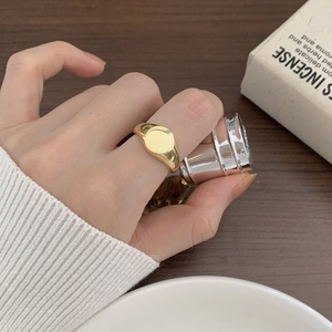 Minimalist 925 sterling silver signet ring with a gold finish worn on a finger