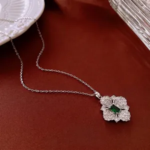 Vintage rhodium plated flower pendant necklace with green rectangular zircon on red silk