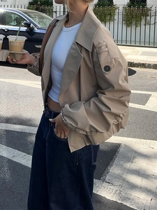 Women's khaki short trench coat jacket with button shoulder detail in a casual loose fit