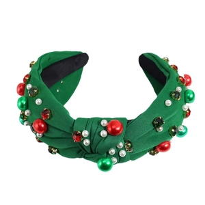 Knotted green fabric headband with festive red pearls and crystal embellishments