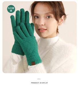Close-up of Mars Green cable knit winter gloves with warm fleece lining and leather label