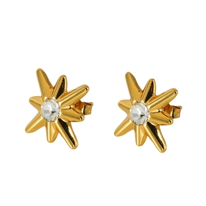 Vintage gold starburst stud earrings with sparkling cubic zirconia on a white background
