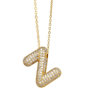 Detailed close-up of a golden balloon-style Z letter pendant encrusted with shiny diamonds