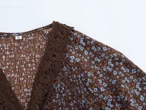 Close-up of brown floral V-neck dress with shirred fabric and crochet lace edge