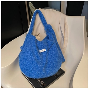Detail of royal blue plush tote bag featuring a soft faux fur texture and knotted strap
