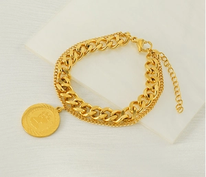 Close-up of gold-plated double-layer chain bracelet featuring an Elizabeth II coin pendant