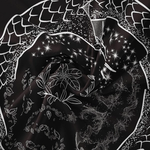 Detailed close-up of bohemian tapestry fabric with artistic dragon scale and star prints