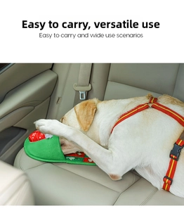 Portable Christmas-themed pet snuffle mat shown in car backseat with a golden retriever dog