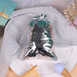 Silver drawstring jewelry pouch with metallic luster fabric and elegant floral accents