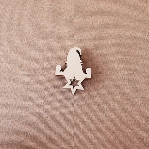 Close-up of wooden gnome countdown calendar with a star cutout on natural wood texture