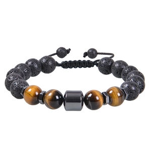 Macro detail of 10mm tiger eye and lava stone beads on an adjustable woven bracelet