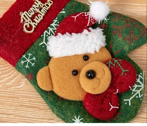 Detail of Christmas stocking with 3D teddy bear, green felt, and Merry Christmas sign