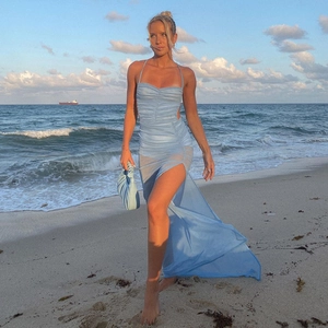 Detail view of light blue backless dress with ruched design and high side slit