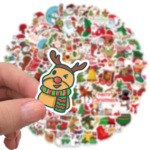 Hand holding a colorful cartoon reindeer sticker from a 100-piece Christmas sticker pack