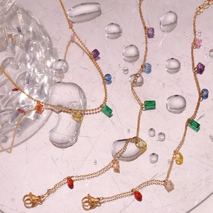 Macro view of gold stainless steel necklace with multi-colored geometric gemstones