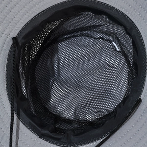 Detail of outdoor sun hat showing breathable black mesh lining and reinforced stitching