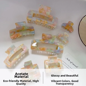 Macro view showing various sizes of colorful marble texture acetate hair claws