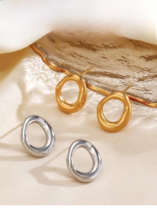 Detailed macro shot of irregular geometric hollow stud earrings in gold and silver finish