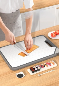 Macro view of stainless steel cutting board with salmon slices on a modern kitchen counter