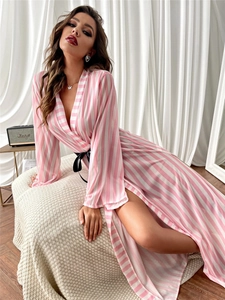 Detail view of pink striped silk sleepwear with deep V-neck and black satin waist tie