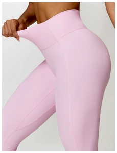 Gros plan du pantalon de yoga rose clair taille haute montrant la grande élasticité