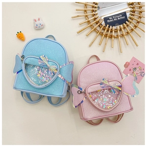Detail view of pink and blue sequin girls backpacks with laser heart bows and accessories