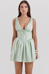 Detailed close-up of V-neck pleats and cinched waist on light green mini dress