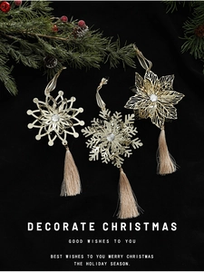 Three gold metal Christmas ornaments with silk tassels and pine branch decoration