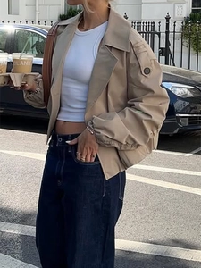Women's khaki button-up lapel jacket with a loose fit and pockets in an urban street style