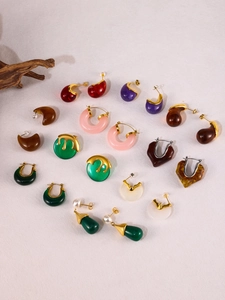 Artistic collection of colorful resin earrings featuring gold accents and pearl details